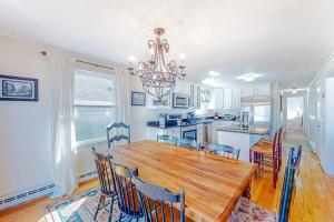 a kitchen and dining room with a wooden table and chairs at The Sea Captain's Sanctuary in Ocean City