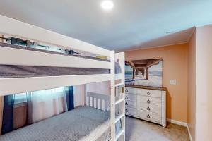 a bedroom with two bunk beds and a dresser at Montego Bay - Atlantic 13300 in Ocean City +25 photos