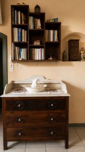 a wooden dresser with a bowl on top of it at The Blue - Kythira in Kondoliánika