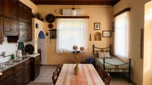 a kitchen with a table and a dining room at The Blue - Kythira in Kondoliánika