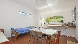 a kitchen and dining room with a table and chairs at Pinchin's Place in Brunswick Heads