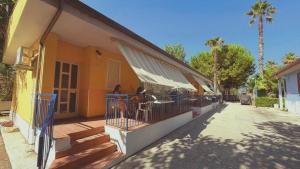 a building with people sitting at tables on a balcony at JuliaMare Village in Giulianova