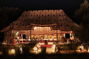 a large tent with birds on it at night at Palais Zoya in Marrakesh