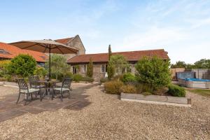 a patio with a table and chairs and an umbrella at 1 Bed in Bristol oc-85559 in Langford