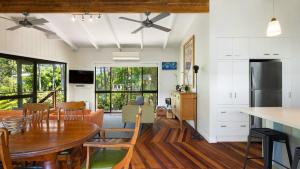 a kitchen and dining room with a table and chairs at L'Aqua by Lifestyle. in New Brighton