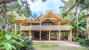 a house with a wrap around deck in the woods at MiaCasa in New Brighton +5 photos