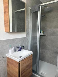 a bathroom with a sink and a shower at Modernes Gästezimmer am Biggese in Attendorn