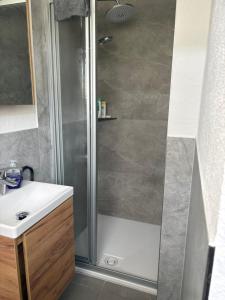 a bathroom with a shower and a sink at Modernes Gästezimmer am Biggese in Attendorn