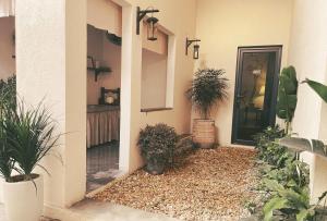 a front door of a house with potted plants at Monoi Home in Vinh