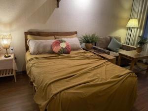 a bed with two pillows on it in a bedroom at Monoi Home in Vinh