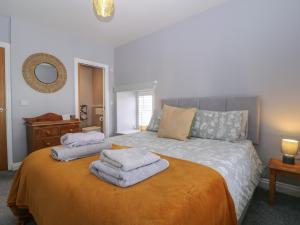 a bedroom with a bed with towels on it at 19 Lion Street in Hereford
