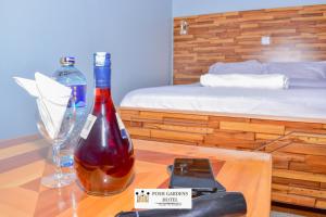 a bottle of wine on a table next to a bed at Posh lounge gardens in Gatimu +12 photos