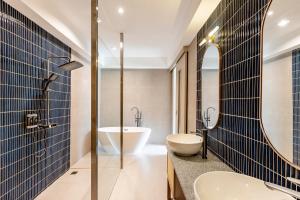 a bathroom with two sinks and a mirror at Taladnoi 24 Hostel in Bangkok +78 photos