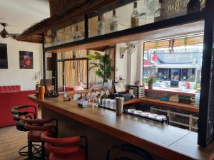 a bar in a restaurant with two red chairs at Lucky Buako Hotel Patong in Patong Beach