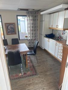 a kitchen and dining room with a table and chairs at Carlssons matsalar in Gislaved