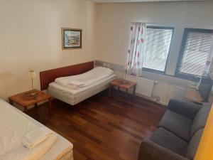 a small room with a bed and a couch at Carlssons matsalar in Gislaved