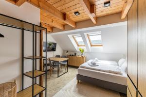 a bedroom with a bed and a dining room at Stejkárna Špičák in Špičák