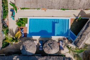 an overhead view of a swimming pool in a resort at King Simba Apartment Hotel & Restaurant in Bwejuu