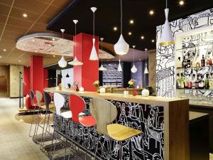 a bar with a bunch of chairs in a room at ibis Hotel Hamburg Alster Centrum in Hamburg