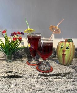 two wine glasses and a pumpkin with a face on it at LUMBINI B&b in Kandy