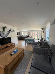 a living room with a couch and a coffee table at Fort View- Totland in Totland