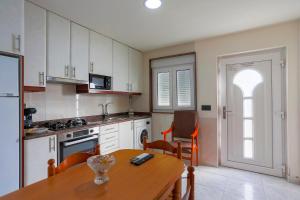 a kitchen with a wooden table and a dining room at Apartamento Playa de Lires in Cee