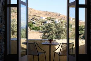 a table and chairs on a balcony with a view at Domotel Kea in Koundouros