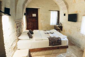 a bedroom with a large bed in a room at MMF cave house in Nevşehir