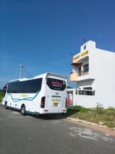 a white bus parked in front of a building at Cherry House villa in Hà Tiên