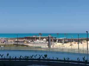 a view of a beach with the ocean in the background at Studio Alamein towers in El Alamein