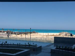 a view of the beach from the balcony of a condo at Studio Alamein towers in El Alamein