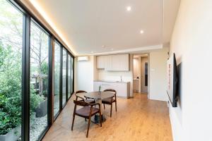 a kitchen and dining room with a table and chairs at Taladnoi 24 Hostel in Bangkok