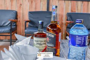 a bottle of alcohol and a bottle of water on a table at Posh lounge gardens in Gatimu