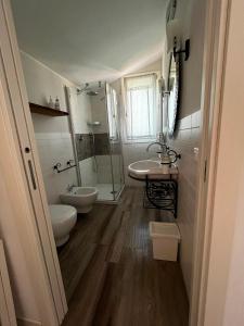 a bathroom with two sinks and a shower at B&B Nadine Forlì - boutique eco stay con parcheggio gratuito in Forlì +24 photos