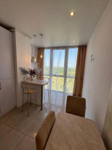 a living room with a table and a dining room at Panorama Apartment in Lviv