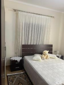 a teddy bear sitting on a bed in a bedroom at Stone House Leskovik in Leskovik