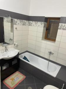 a bathroom with a tub and a sink and a toilet at Stone House Leskovik in Leskovik