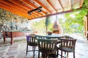 an outdoor kitchen with a table and chairs and a fireplace at Casa Emblemática Garaday Lanzarote. in Tinajo