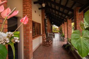 a brick building with a brick walkway with flowers at SHERBOURNE LODGE in Kitwe