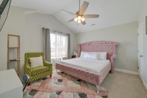 a bedroom with a pink bed and a chair at Great for Groups! 2 Centrally Located Concord Gems in Concord