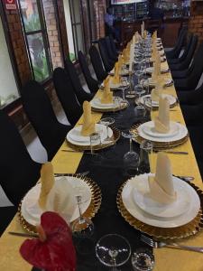 a long table with plates and hats on it at SHERBOURNE LODGE in Kitwe