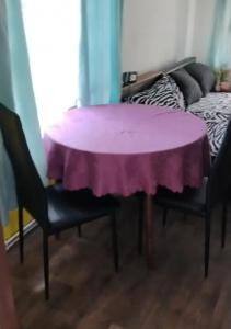 a purple table in a room with two chairs at Vejminek u hospodářství Obora u Doks in Doksy