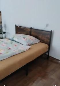 a bed in a room with a wooden head board at Vejminek u hospodářství Obora u Doks in Doksy