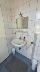 a bathroom with a sink and a mirror at Goode Wind in Norden