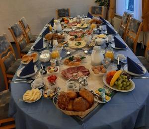 a long table with plates of food on it at Goode Wind in Norden