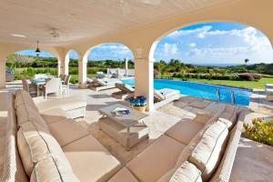 an estate with a swimming pool and a patio at Fairway Views with Private Pool - High Spirits in Saint James