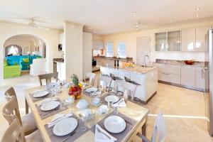a dining room and kitchen with a table and chairs at Fairway Views with Private Pool - High Spirits in Saint James