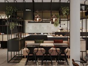 a kitchen with a table and chairs and a counter at ibis Konstanz in Konstanz