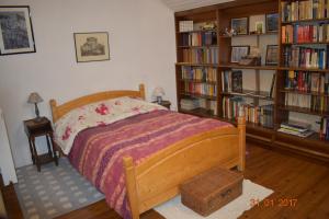 a bedroom with a bed and book shelves filled with books at Chalet de l'Esquirol in Bolquere Pyrenees 2000