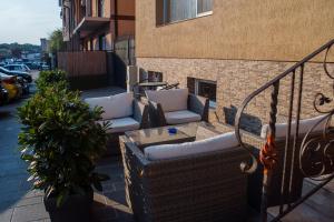 a balcony with couches and a plant on a building at Vila Cristal in Baile Felix